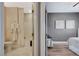 Split view showcasing a clean bathroom and tranquil gray toned bedroom at 3728 Richard Allen Ct, Las Vegas, NV 89147