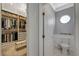Well-organized walk-in closet alongside a half bathroom with decorative accents at 3728 Richard Allen Ct, Las Vegas, NV 89147