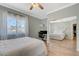 Bright bedroom features a work area, ceiling fan, and sliding mirror door at 3728 Richard Allen Ct, Las Vegas, NV 89147