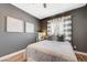 This bedroom is elegantly decorated with a dark gray accent wall and plush bedding at 3728 Richard Allen Ct, Las Vegas, NV 89147