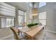 A dining area filled with natural light featuring a wooden table, plants, and serene outdoor views at 3728 Richard Allen Ct, Las Vegas, NV 89147