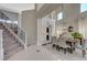 Inviting dining area next to a staircase featuring stylish furnishings and abundant natural light at 3728 Richard Allen Ct, Las Vegas, NV 89147