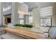 A dining area filled with natural light featuring a wooden table, plants, and serene outdoor views at 3728 Richard Allen Ct, Las Vegas, NV 89147