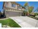 Side view of the house with a three-car garage, lush landscaping and a spacious concrete driveway at 3728 Richard Allen Ct, Las Vegas, NV 89147