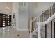Inviting foyer with tiled floors, a chandelier, and a staircase with modern railings, leading to the upper level at 3728 Richard Allen Ct, Las Vegas, NV 89147