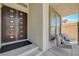 Inviting front porch featuring comfortable seating, stone pillars, and a secure entryway at 3728 Richard Allen Ct, Las Vegas, NV 89147