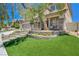 Home featuring a landscaped front yard with an inviting entryway with lush plants and comfortable seating at 3728 Richard Allen Ct, Las Vegas, NV 89147