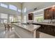 Bright and spacious kitchen leading to the dining area with stainless steel appliances and modern countertops at 3728 Richard Allen Ct, Las Vegas, NV 89147
