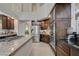 This kitchen features granite counters, stainless appliances, an island with cooktop and ample cabinet space at 3728 Richard Allen Ct, Las Vegas, NV 89147
