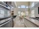 Bright and spacious kitchen leading to the dining area with stainless steel appliances and modern countertops at 3728 Richard Allen Ct, Las Vegas, NV 89147