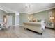 Spacious main bedroom with wood floors, natural light, and access to a luxurious en-suite bathroom at 3728 Richard Allen Ct, Las Vegas, NV 89147