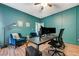 Stylish office with blue walls, wood floors, and comfortable seating with modern desk and computer setup at 3728 Richard Allen Ct, Las Vegas, NV 89147