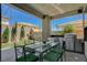 Outdoor kitchen and covered patio with dining table, perfect for entertaining at 3728 Richard Allen Ct, Las Vegas, NV 89147