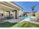 Covered patio with dining set, lawn, and backyard pool view at 3728 Richard Allen Ct, Las Vegas, NV 89147