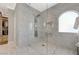 Modern bathroom featuring a glass shower with marble tile surround and open access to a walk-in closet at 3728 Richard Allen Ct, Las Vegas, NV 89147