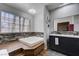 Modern bathroom features a soaking tub with decorative tile and a double sink vanity at 3928 Edgemoor Way, Las Vegas, NV 89121