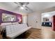 Bedroom with wood floors, a white futon, and a view into the Primary bathroom at 3928 Edgemoor Way, Las Vegas, NV 89121