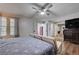 Spacious bedroom featuring wood-look floors, a ceiling fan, and multiple doorways at 3928 Edgemoor Way, Las Vegas, NV 89121