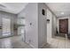Bright entryway features neutral tile flooring, a view to the kitchen, and a classic wood front door at 3928 Edgemoor Way, Las Vegas, NV 89121