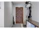 Welcoming entryway featuring a wood door, a coat rack, and a neutral color scheme at 3928 Edgemoor Way, Las Vegas, NV 89121