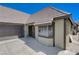 Exterior view features a two-car garage with window and front entrance at 3928 Edgemoor Way, Las Vegas, NV 89121