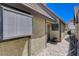 Exterior side view of home, featuring a stone walkway and window at 3928 Edgemoor Way, Las Vegas, NV 89121