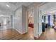 Hallway with wood floors leading to bedrooms and other living spaces, offering a bright and airy feel at 3928 Edgemoor Way, Las Vegas, NV 89121