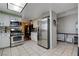 Bright kitchen featuring stainless steel appliances, white cabinets, and tiled flooring at 3928 Edgemoor Way, Las Vegas, NV 89121