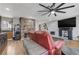 Cozy living room featuring a stone fireplace, flat-screen TV, and comfortable seating at 3928 Edgemoor Way, Las Vegas, NV 89121