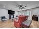 Inviting living space with a mounted TV, red sofa, and laminate wood flooring at 3928 Edgemoor Way, Las Vegas, NV 89121