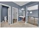 Bathroom featuring vanity, toilet, and door to walk-in closet and bedroom at 4063 Lower Saxon Ave, North Las Vegas, NV 89085