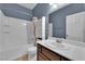 Bathroom with tub-shower combo, vanity and tiled flooring at 4063 Lower Saxon Ave, North Las Vegas, NV 89085