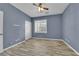 Cozy bedroom with wood-look tile flooring, plantation shutters, and a closet at 4063 Lower Saxon Ave, North Las Vegas, NV 89085