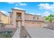 Two-story home featuring a three-car garage, balcony, neutral tones, and landscaped front yard at 4063 Lower Saxon Ave, North Las Vegas, NV 89085