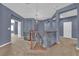 Upstairs hallway with a decorative railing, carpet flooring, and plenty of natural light at 4063 Lower Saxon Ave, North Las Vegas, NV 89085
