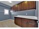 Laundry room with plenty of cabinet space and a tiled floor at 4063 Lower Saxon Ave, North Las Vegas, NV 89085