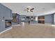 Bright, open-concept living room with a fireplace, tile floors, and a staircase leading to the upper level at 4063 Lower Saxon Ave, North Las Vegas, NV 89085