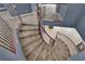 Carpeted winding staircase with dark wood railing and modern design at 4063 Lower Saxon Ave, North Las Vegas, NV 89085