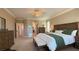 Beautiful bedroom with a large bed, accent chair, and lots of natural light at 4299 Fiore Bella Blvd, Las Vegas, NV 89135
