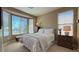 Bright bedroom featuring multiple windows, neutral walls, and matching bedside tables at 4299 Fiore Bella Blvd, Las Vegas, NV 89135