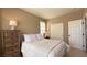 Inviting bedroom with a neutral color palette, featuring matching nightstands and a closet at 4299 Fiore Bella Blvd, Las Vegas, NV 89135