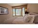 Cozy bedroom with a comfortable bed, bay window, and neutral decor for a relaxing atmosphere at 4299 Fiore Bella Blvd, Las Vegas, NV 89135