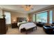 Cozy bedroom featuring a ceiling fan, a window, and a dresser with lamps at 4299 Fiore Bella Blvd, Las Vegas, NV 89135