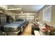 Organized garage featuring a classic car, storage shelves, and ample space for parking and storage at 4299 Fiore Bella Blvd, Las Vegas, NV 89135