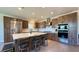 Spacious kitchen with custom wood cabinets, stainless steel appliances, and a large island at 4299 Fiore Bella Blvd, Las Vegas, NV 89135