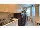 Well-organized laundry room with modern machines, storage, and sink at 4299 Fiore Bella Blvd, Las Vegas, NV 89135