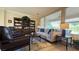 Comfortable living room featuring a large sofa, chairs, bookshelves, and plenty of light at 4299 Fiore Bella Blvd, Las Vegas, NV 89135