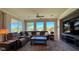 Comfortable living room features a large sectional sofa, ceiling fan, and sliding glass doors at 4299 Fiore Bella Blvd, Las Vegas, NV 89135