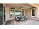 Inviting covered patio with ceiling fan and mountain views offers ideal outdoor dining space at 4299 Fiore Bella Blvd, Las Vegas, NV 89135