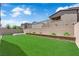 Landscaped backyard featuring green grass, a patio, and a privacy wall at 4428 Mural Glen Ct, North Las Vegas, NV 89084